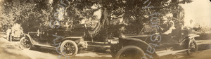 Image of Three automobiles paused on the road for a group photo