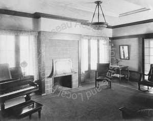 Image of View of a living room with a fireplace, piano, and furniture