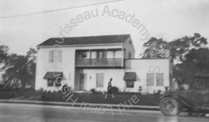 Image of Hempl house, view of front, with an automobile at the curb