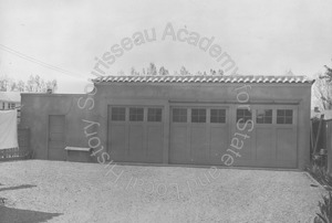Image of Front view of a false-fronted three-car garage and driveway