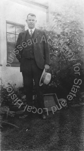Image of Andrew P. Hill, Jr. standing in the yard at his home