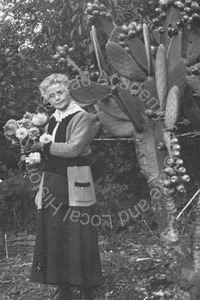 Image of Florence Watkins Hill standing next to a cactus plant in the yard
