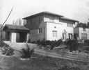 Image of Rear view of Wilson house with porte cochere and view of garden