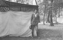 Image of Andrew P. HIll, Jr. standing next to a tent in the forest